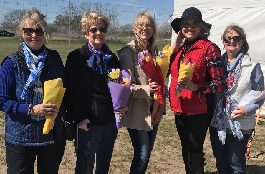 ladies who attended Valentine's social and holding flowers.