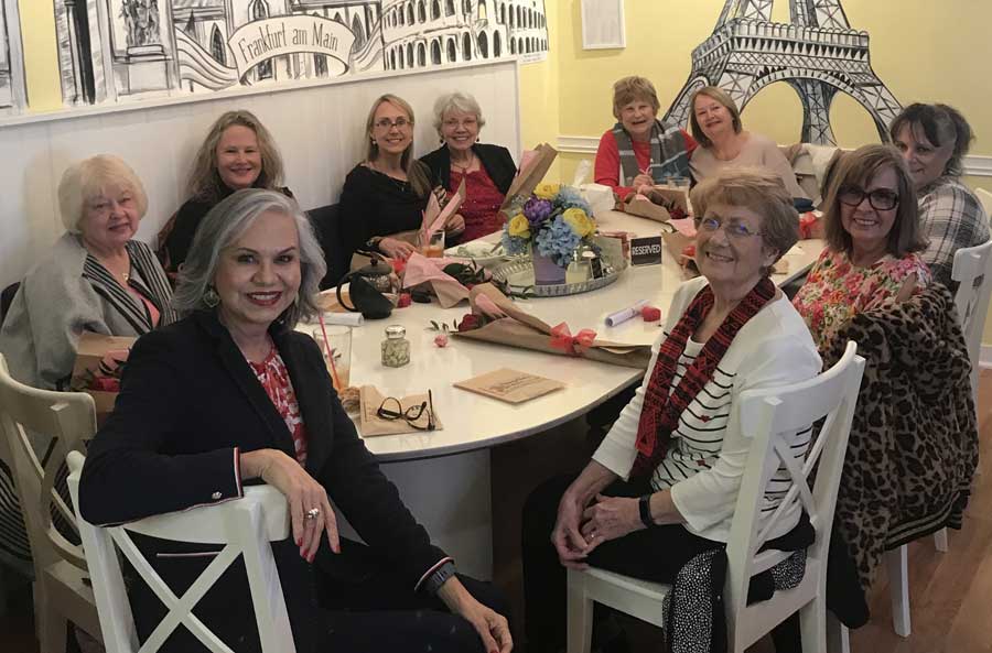 Ladies sitting at table having fun at Valentine's social.