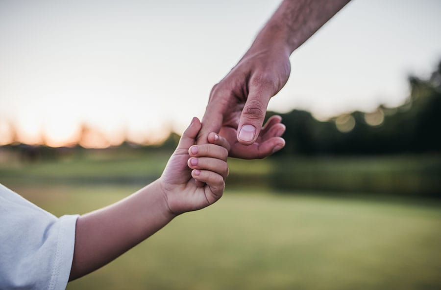 father and child holding hands